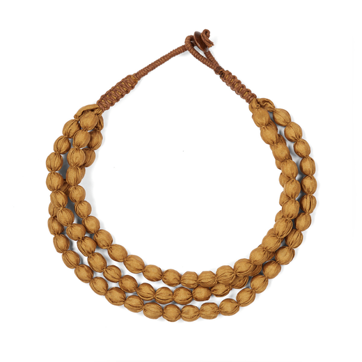 A mustard yellow necklace made of three chunky strands of textile beads.